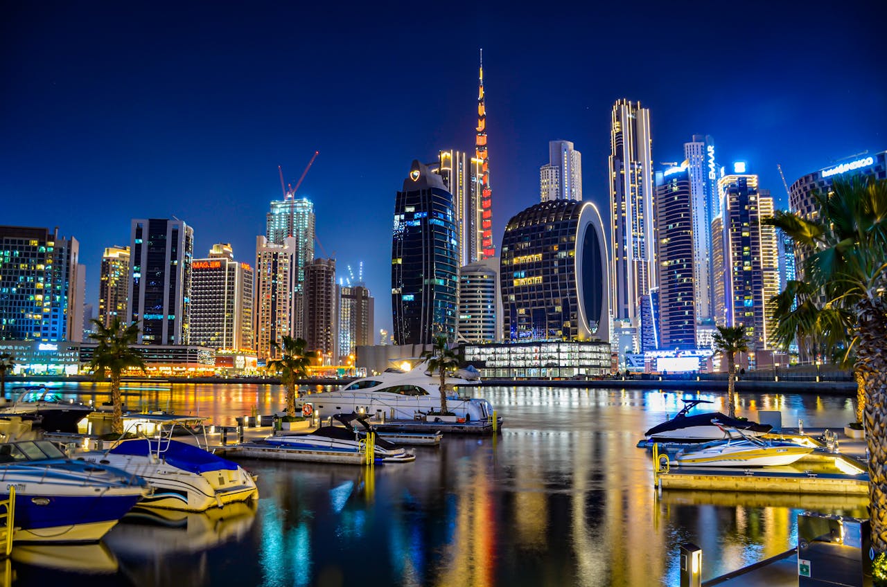 A breathtaking view of Dubai Marina's illuminated skyline and moored yachts at night.