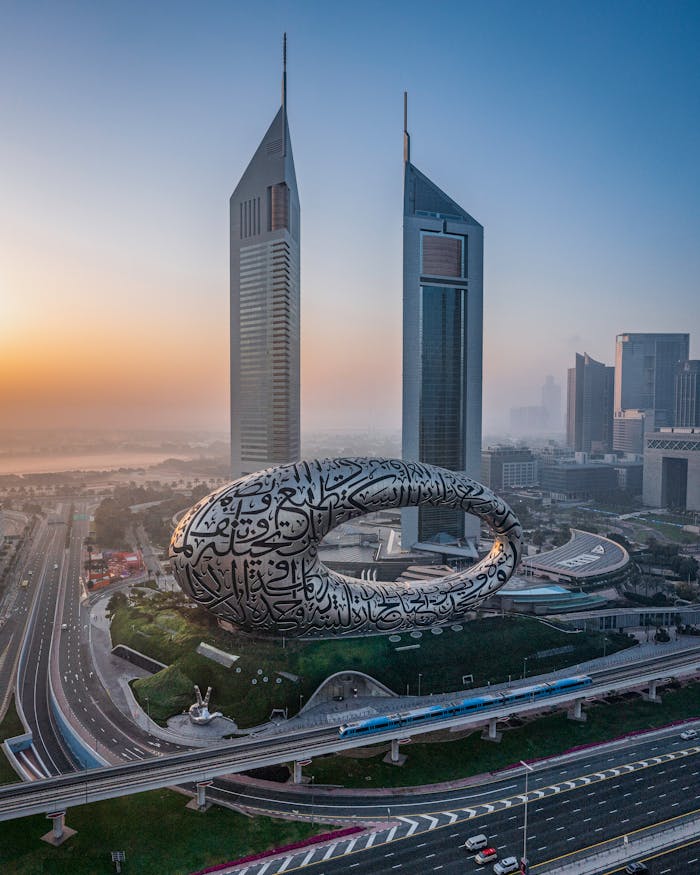 Aerial view of Museum of the Future and Jumeirah Towers at sunrise in Dubai, UAE.